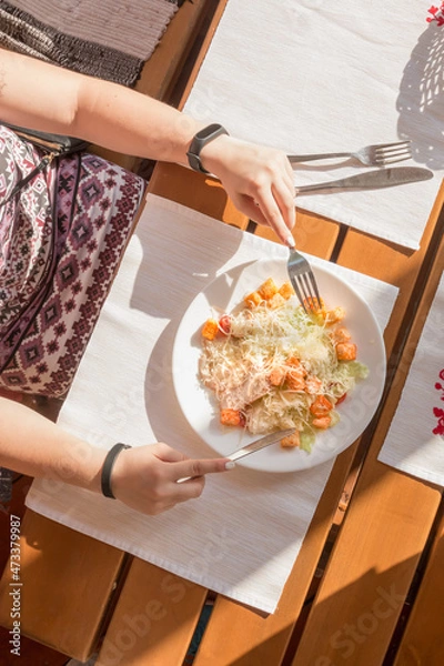 Fototapeta Greek salad with bacon on a white napkin on the table