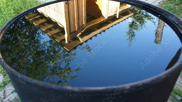 Obraz Reflection of a house in a barrel of water