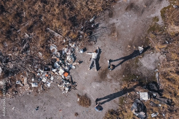Fototapeta the corpse of a murdered teenage girl is examined by an expert found using a drone in a garbage dump during aerial photography to search for missing people, forensic examination