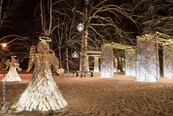 Fototapeta Christmas decor with angels and many gates made of snowy branches, Kuldiga, Latvia
