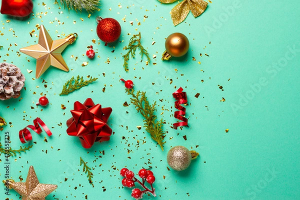 Fototapeta Christmas composition with decorations and ornaments on a mint background