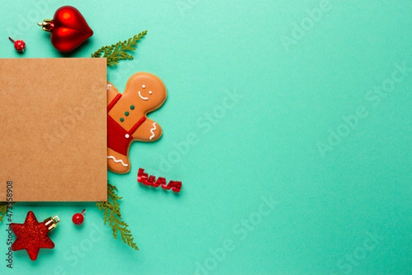 Fototapeta Christmas composition with decorations and cookies on a mint background with space for text