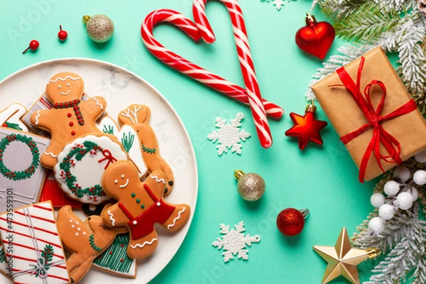Fototapeta Christmas composition with decorations and cookies on a mint background