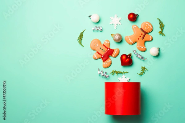 Fototapeta Christmas composition with decorations and cookies on a mint background
