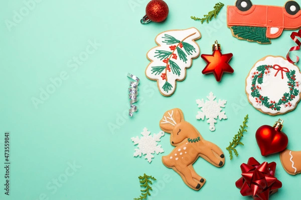 Fototapeta Christmas composition with decorations and cookies on a mint background