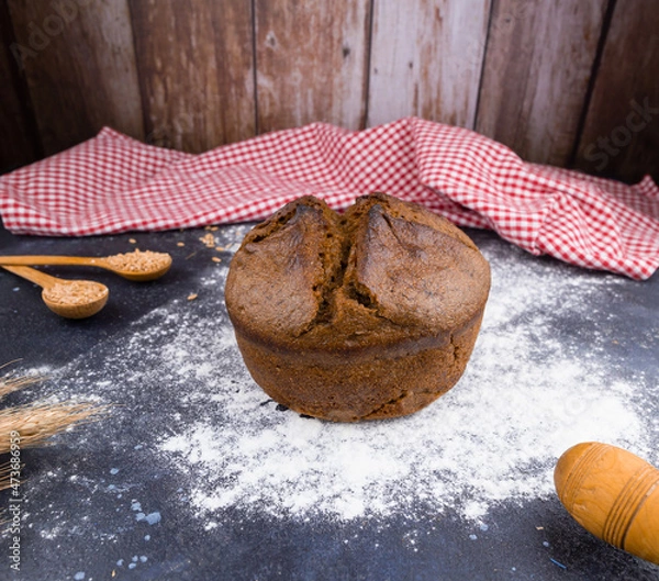 Fototapeta black round bread on a dark table