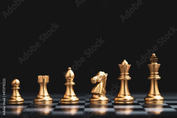 Fototapeta Golden chess include king queen horse ship and pawn on dark background.