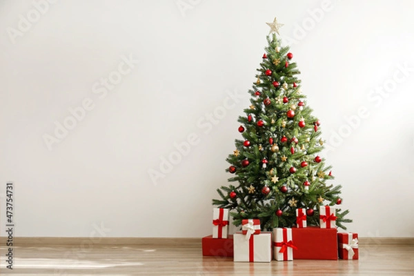 Fototapeta Traditional christmas pine tree with holiday decorations, copy space for text. Decorative lights glowing on fir. Close up, background, interior.