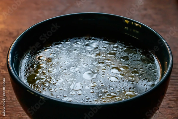 Obraz close up details of oil on water texture in blue soup bowl