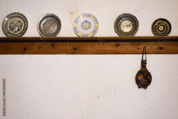 Obraz A set of old-fashioned plates arranged on a white kitchen wall