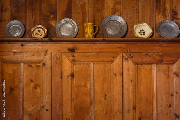 Obraz A set of old-fashioned plates arranged on a wooden kitchen wall