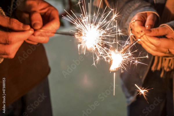 Fototapeta Lighting sparkler with friends. Festive mood celebration