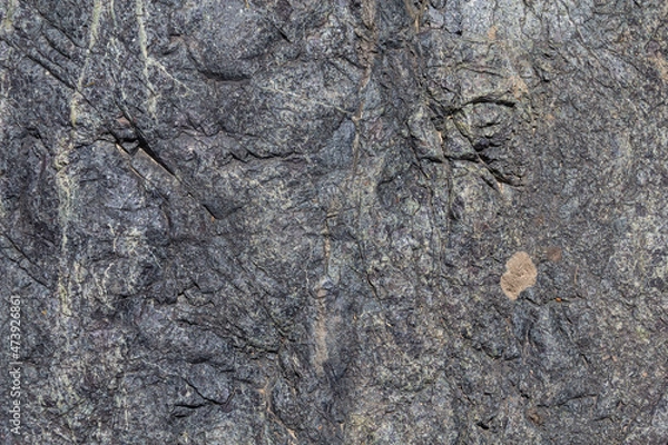 Fototapeta Stone texture. Closeup of the rough texture of a big rock. Surface of the stone for natural background. Closeup blurred stone background texture. a rock