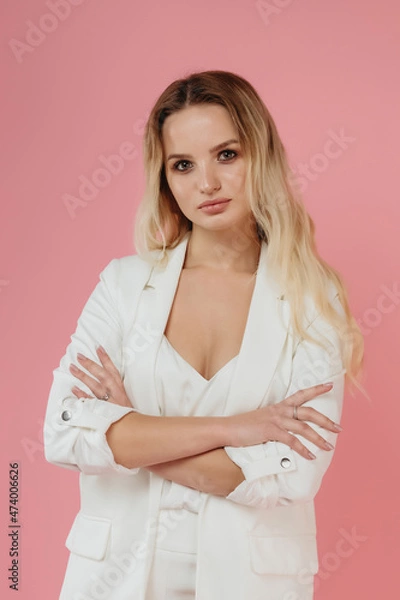 Obraz beautiful girl in a white suit on a pink background
