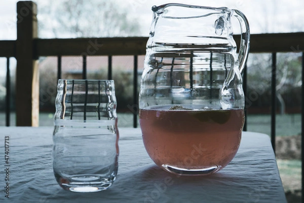 Fototapeta Close up of Pink lemonade in pitcher on table
