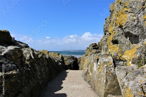 Obraz Path between cliff rocks with blue skies