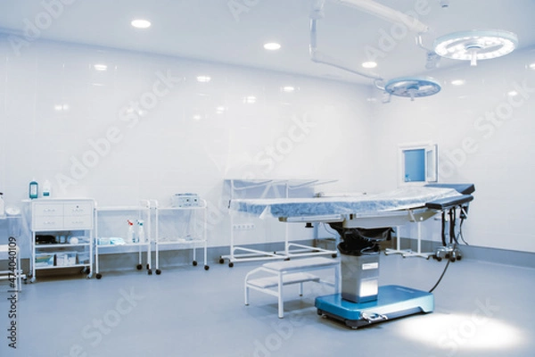 Fototapeta Empty operating room in a hospital. Surgical equipment with operating table. Medical device for emergency patient in blue tone style. Blank Emergency Surgery Room. Clinic interior for background.