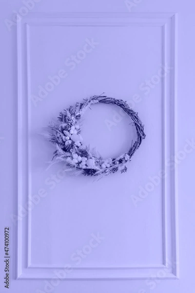 Fototapeta Beautiful Christmas white wreath with cones. Toned in trendy Very Peri color of the Year 2022