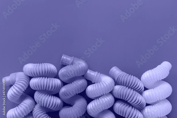 Fototapeta Colorful anti-stress fidget pop tube sensory toy. Toned in trendy Very Peri color of the Year 2022