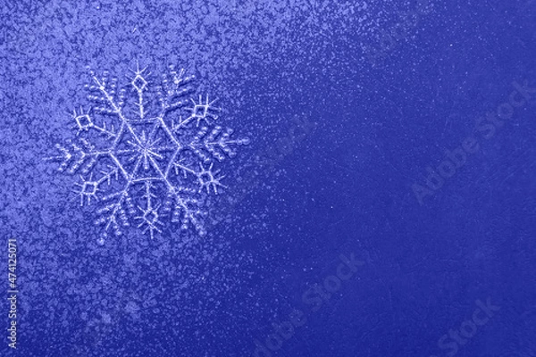 Obraz Minimalistic christmas background, silver snowflake and glitter on blue backdrop