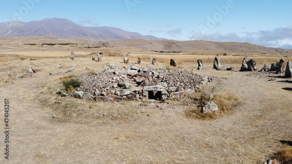 Obraz Aerial view of megalithic standing stones and burial mound of Zorats Karer or Carahunge - prehistoric monument in Armenia. Armenian Stonehenge stock photography