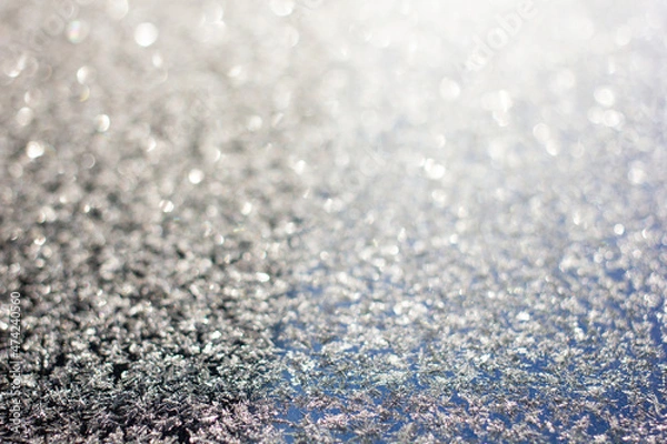 Fototapeta Photo of ice crystals on a smooth surface with blurred backgrounds and bokeh