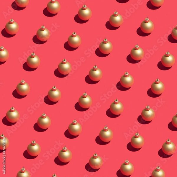 Obraz Christmas decor concept with golden baubles on dark pink background. Minimal pattern visual composition, New Year and winter holiday abstract idea.