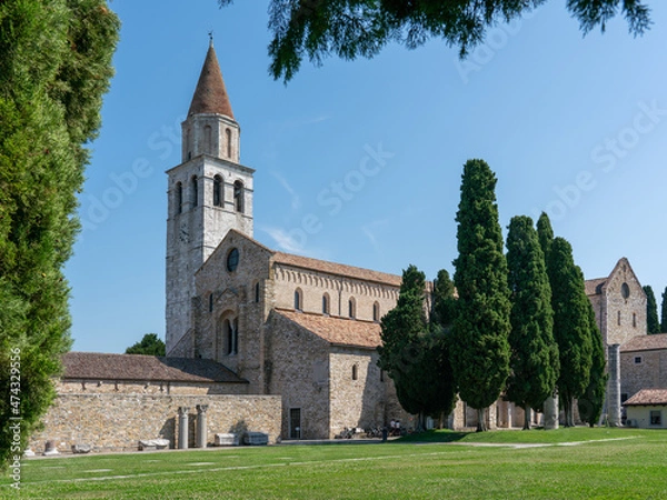Fototapeta Basilica of Aquileia with cypress trees, and lawn in the foreground