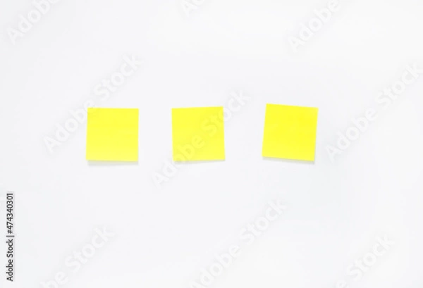 Obraz three yellow sticky notes on a white background