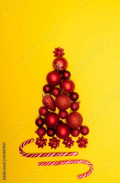 Fototapeta Christmass flatlay Christmas tree lined with Christmas tree decorations and lollipops