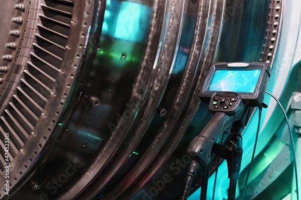 Fototapeta Borescope camera display on a tripod located at the turbine, Inspection of internal parts of a jet engine.