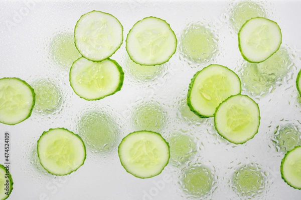 Fototapeta Fresh cucumber with many round slices background.