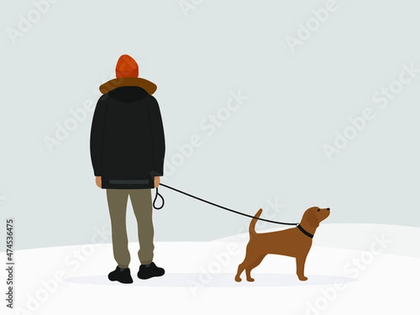 Obraz Male character in a jacket and a hat walking with a dog on a leash in winter