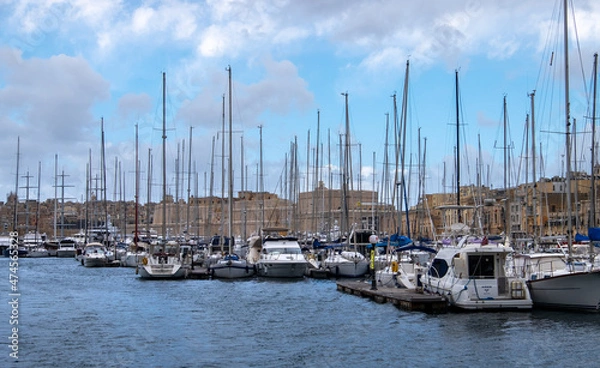 Fototapeta Anchorage of yachts and ships off the coast of the town of Birgu. Water space of Valletta. Malta.