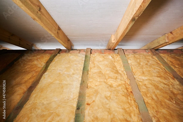 Fototapeta Warming of the roof with mineral wool. Repairing of the house, floor heating insulation, warm attic, eco-friendly insulation