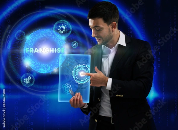 Fototapeta Business, Technology, Internet and network concept. Young businessman working on a virtual screen of the future and sees the inscription: Franchise