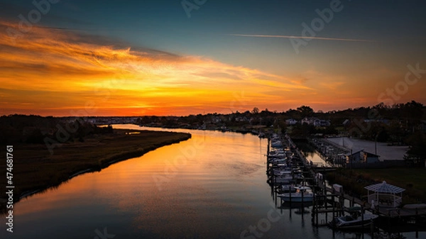 Fototapeta Veteran's Day Sunrise
A beautiful sunrise over the Lewes/Rehoboth canal in Delaware.  I decided to fly the drone to capture the boats and reflection of the sunset on the canal