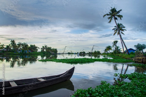 Obraz Wooden fishing  boat on river - Backwaters photography, typical landscape with palm trees and old hut, Kerala Backwaters, Kerala backwaters photography during day time Kadamakkudy Kerala