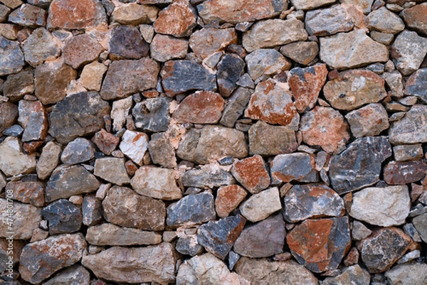 Obraz Textured background of masonry wall made of natural multicolored stones.