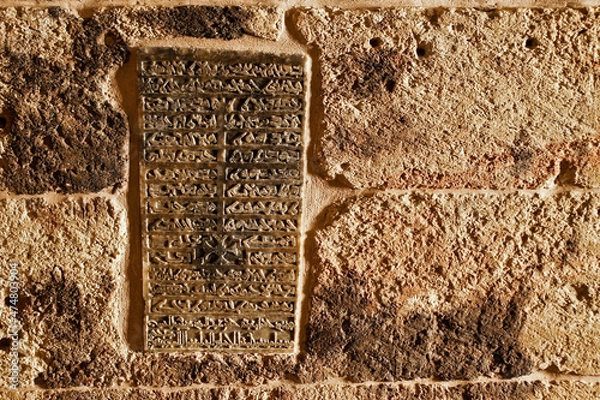 Fototapeta A stone tablet carved in Aramaic script lists the names of the patriarchs entombed at Deyrulzafaran Monastery in Mardin, Eastern Anatolia, Turkey