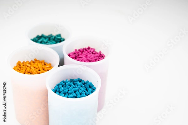 Fototapeta Plastic granules close up for holding,Colorful Plastic granules with white background.