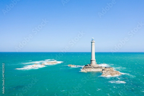 Fototapeta The Lighthouse of Cap de la Hague and the waves of the English Channel in Europe, France, Normandy, Manche, in spring on a sunny day.