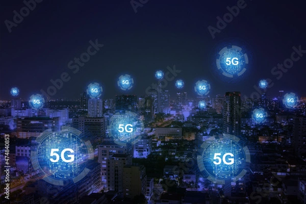 Fototapeta Abstract dark night city backdrop with glowing 5G circuit hologram. Internet speed, ubanization, communication and connection concept. Double exposure.