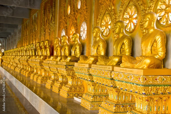 Fototapeta row of golden monk buddhist statues in thai temple, Chaimongkhol
