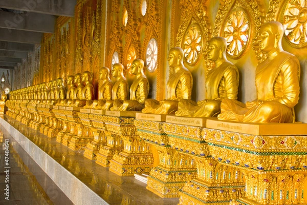Fototapeta row of golden monk buddhist statues in thai temple, Chaimongkhol