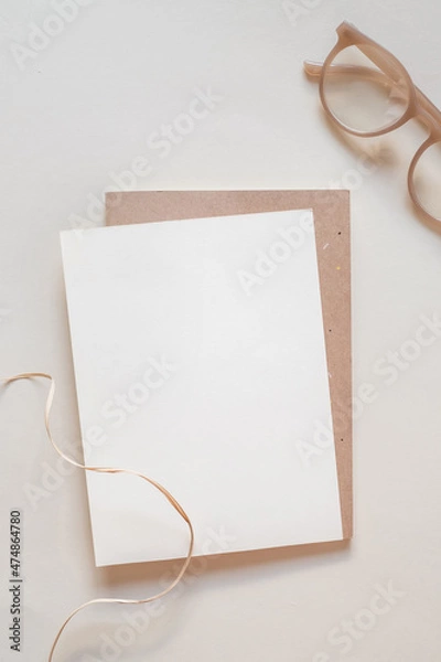 Fototapeta Mockup paper and kraft envelope copy space. Flat lay beige natural background