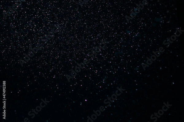 Obraz abstract purple on black bokeh background overlay layer. sparks and blowing. festive background. Sparkling magical dust particles.