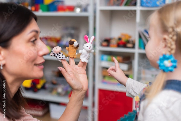 Obraz Woman speech therapist teaches a girl the correct pronunciation and literate speech