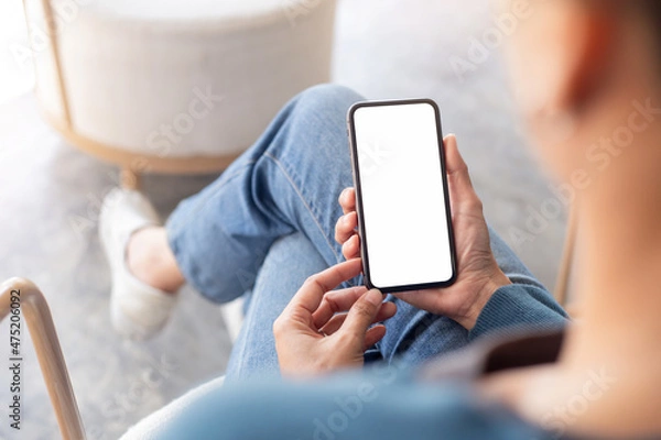 Fototapeta cell phone blank white screen mockup.hand holding texting using mobile on desk at office.background empty space for advertise.work people contact marketing business,technology