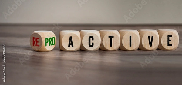 Obraz Cubes, dice or blocks with reactive and proactive on a wooden background